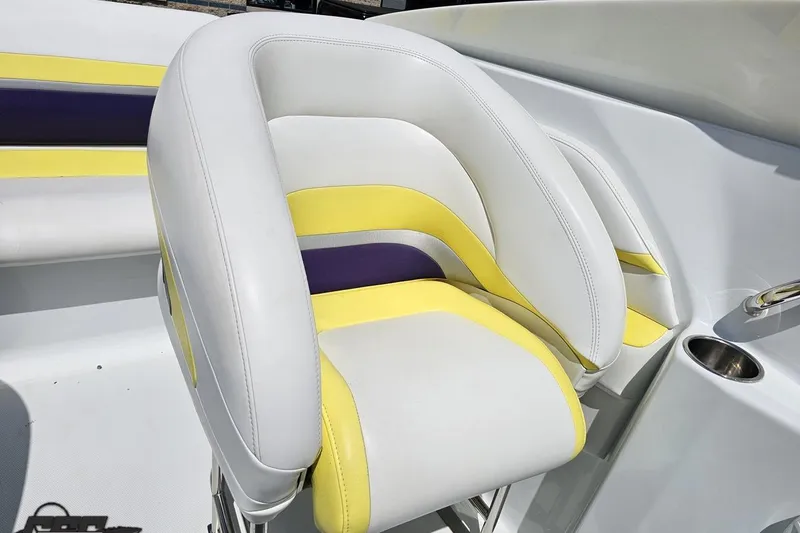 Slide: The Image of 2005 Baja 245 boat seat with white, yellow, and purple upholstery. - 77