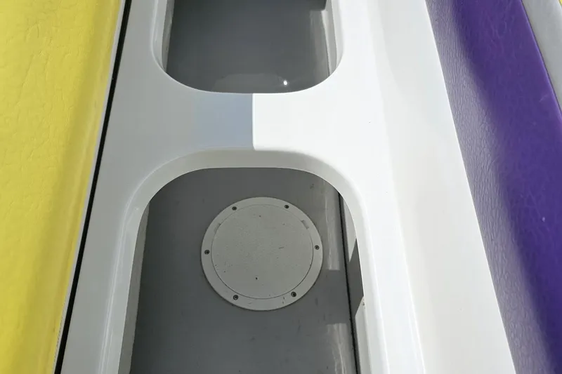 Slide: The Image of Interior view of a 2005 Baja 245 boat with colorful seating. - 80