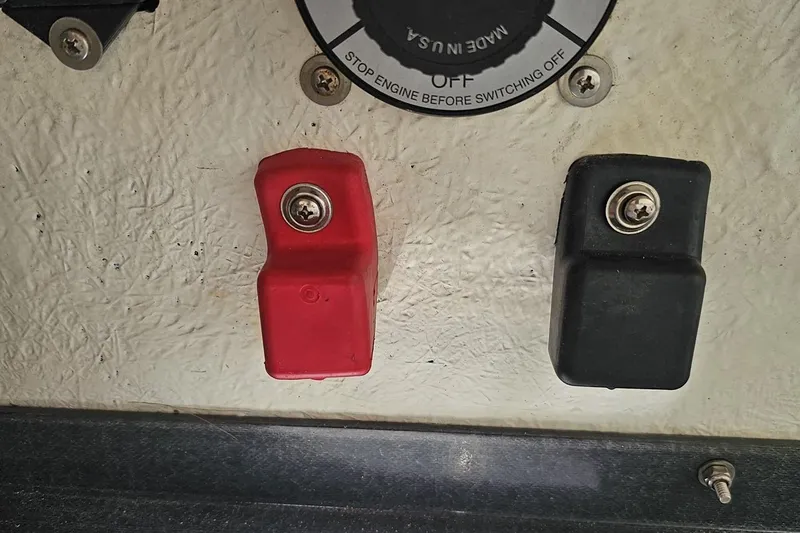 Slide: The Image of Red and black battery terminals on a 2005 Baja 245 boat. - 81