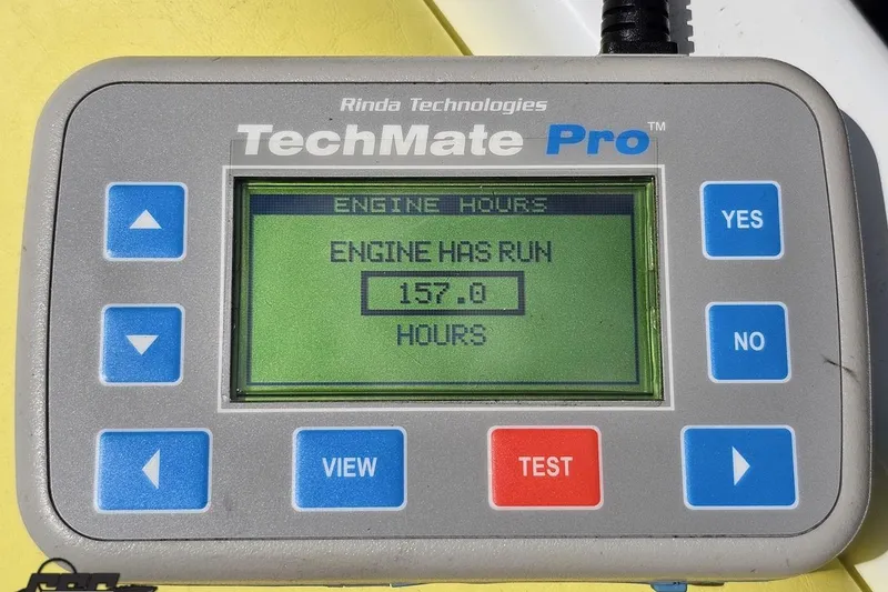 Slide: The Image of TechMate Pro engine hour meter displaying 157 hours for 2005 Baja 245. - 86