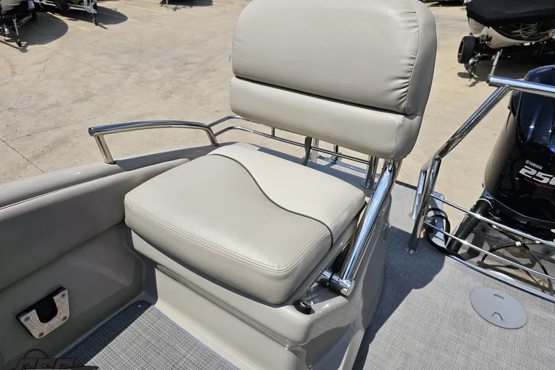Slide: The Image of 2016 Manitou 23 Legacy boat seat with chrome accents and Yamaha engine in background. - 102