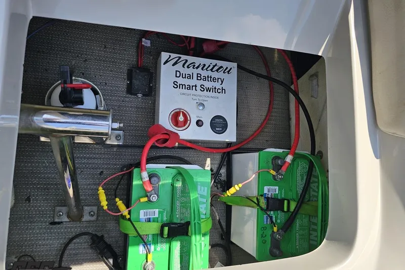 Slide: The Image of 2016 Manitou 23 Legacy dual battery smart switch with green batteries and wiring. - 105