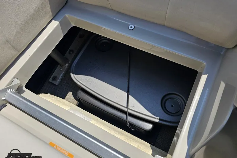 Slide: The Image of Storage compartment in 2016 Manitou 23 Legacy boat, featuring secure lid and durable construction. - 111
