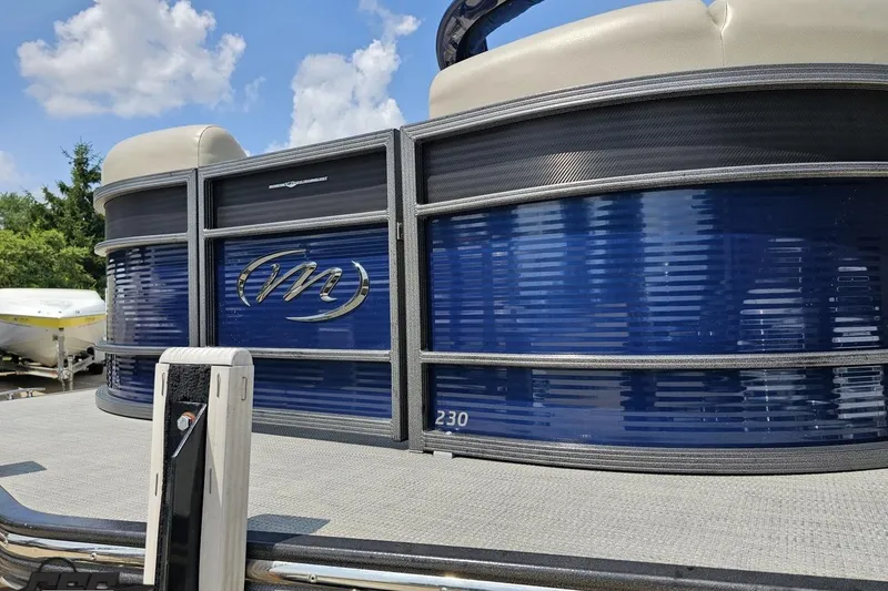 Slide: The Image of 2016 Manitou 23 Legacy pontoon boat with blue exterior and sleek design. - 26