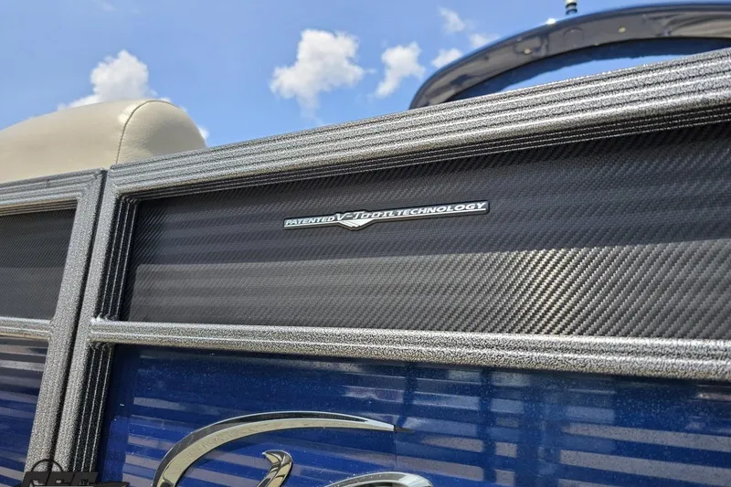 Slide: The Image of 2016 Manitou 23 Legacy boat with patented V-Toon technology, blue sky background. - 27