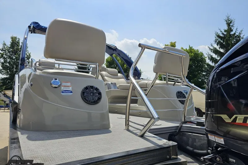 Slide: The Image of 2016 Manitou 23 Legacy pontoon boat with seating and railing, under a clear sky. - 45