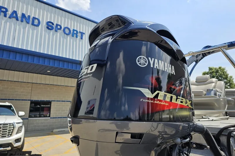 Slide: The Image of Yamaha VMAX 250 outboard motor on 2016 Manitou 23 Legacy boat at dealership. - 47