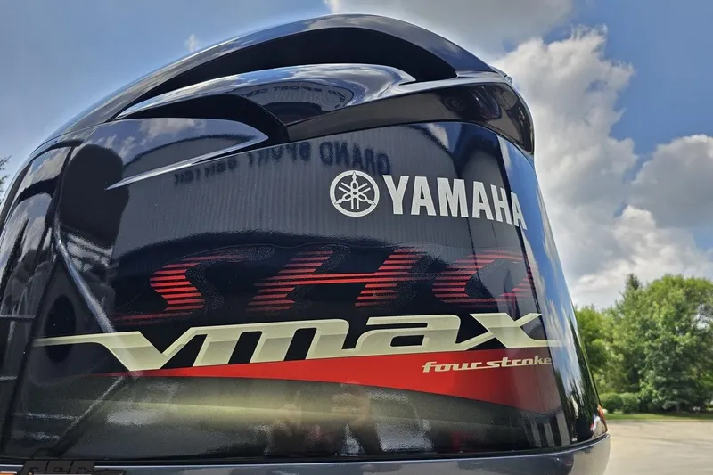 Slide: The Image of Yamaha VMAX SHO four-stroke engine on 2016 Manitou 23 Legacy boat, under a blue sky. - 49