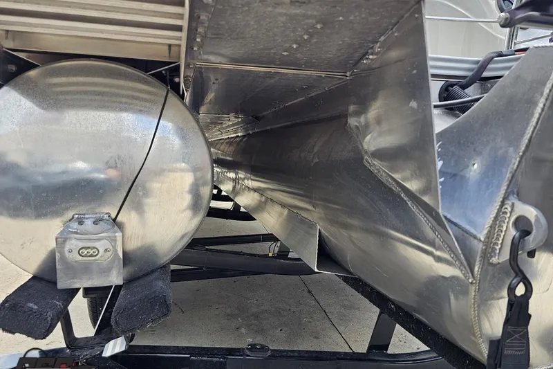 Slide: The Image of Underneath view of a 2016 Manitou 23 Legacy pontoon boat, showcasing its aluminum structure. - 51