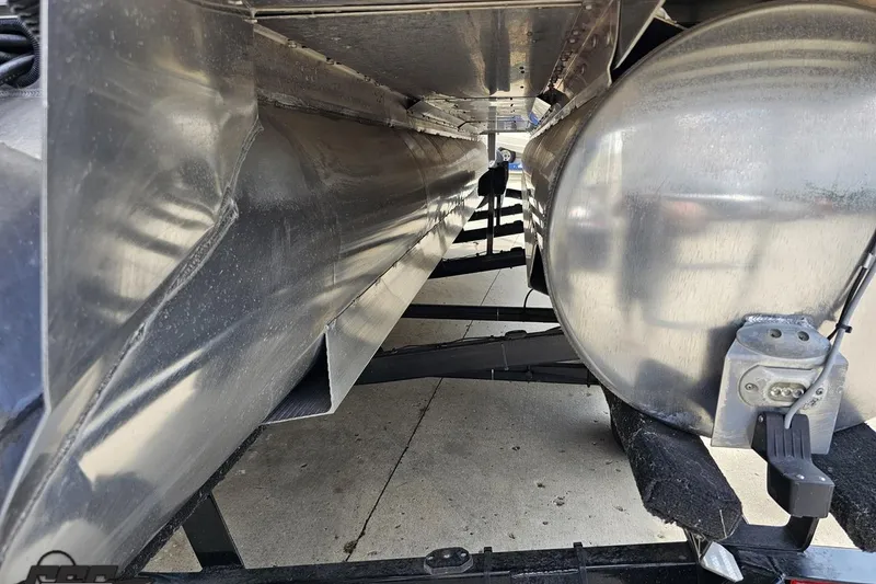 Slide: The Image of Underneath view of a 2016 Manitou 23 Legacy pontoon boat, showcasing its aluminum pontoons. - 52