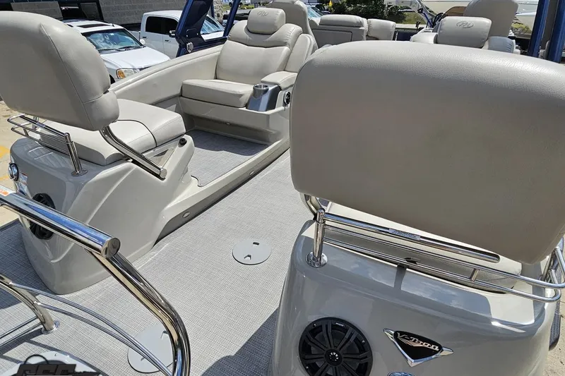 Slide: The Image of 2016 Manitou 23 Legacy boat interior with beige seating and modern design. - 53