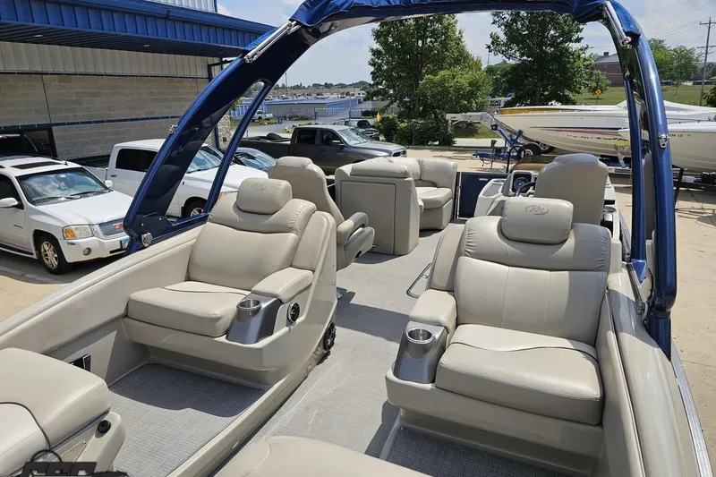 Slide: The Image of 2016 Manitou 23 Legacy pontoon boat with luxurious beige seating and modern design. - 54