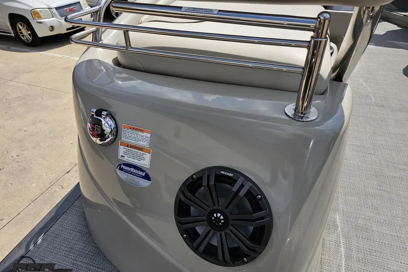 Slide: The Image of 2016 Manitou 23 Legacy boat console with speaker and chrome railings. - 56