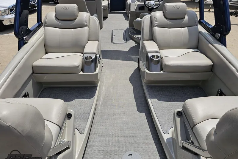 Slide: The Image of 2016 Manitou 23 Legacy boat interior with plush seating and cup holders. - 59