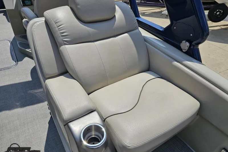 Slide: The Image of Luxurious seating on 2016 Manitou 23 Legacy boat with cup holder, gray upholstery. - 62