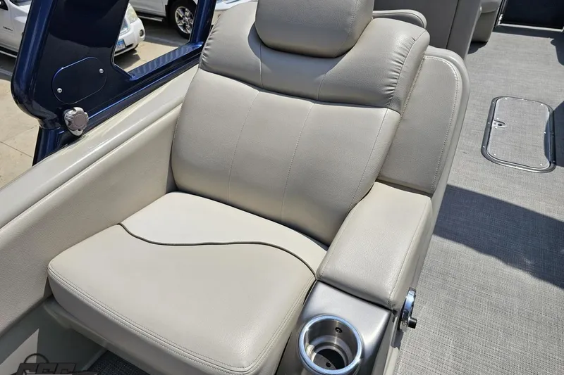 Slide: The Image of Luxurious seating on 2016 Manitou 23 Legacy boat with cup holder and plush upholstery. - 63