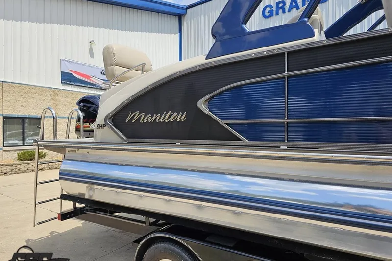 Slide: The Image of 2016 Manitou 23 Legacy pontoon boat with sleek blue and silver design. - 7