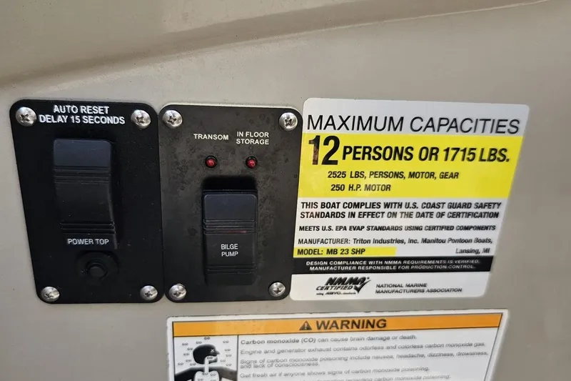 Slide: The Image of Control panel and capacity label on 2016 Manitou 23 Legacy boat. - 71