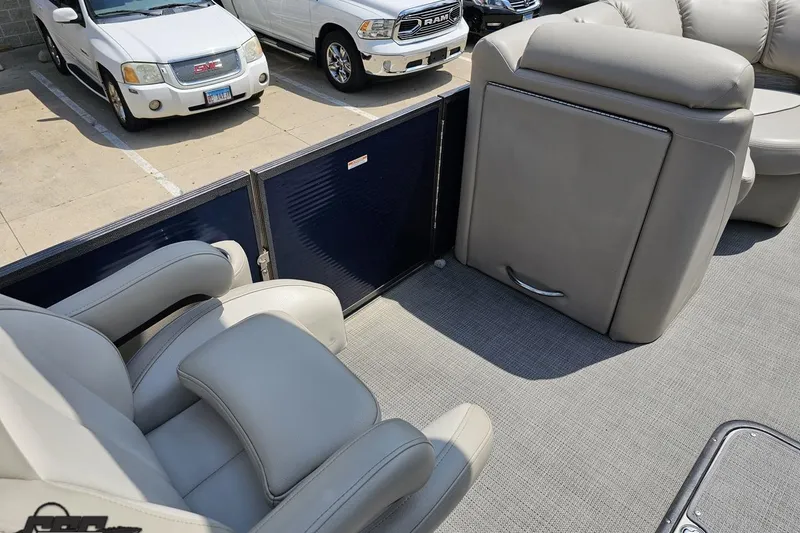 Slide: The Image of 2016 Manitou 23 Legacy boat interior with gray seating and carpeted flooring. - 72