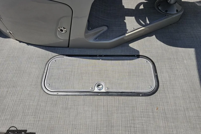 Slide: The Image of 2016 Manitou 23 Legacy boat floor with storage hatch and textured surface. - 75