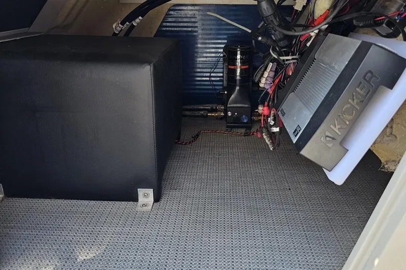 Slide: The Image of Interior of 2016 Manitou 23 Legacy showing audio equipment and wiring setup. - 77