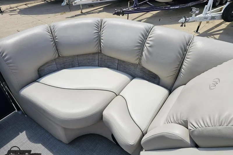 Slide: The Image of Luxurious seating on 2016 Manitou 23 Legacy pontoon boat, featuring plush gray upholstery. - 79