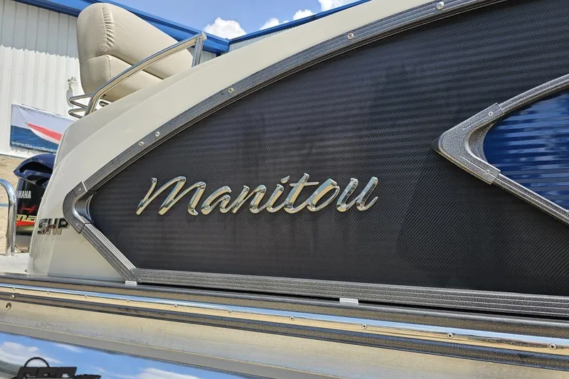 Slide: The Image of 2016 Manitou 23 Legacy boat with sleek design and elegant branding. - 8