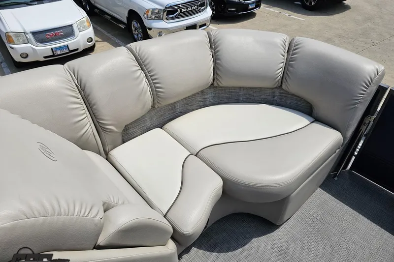 Slide: The Image of 2016 Manitou 23 Legacy boat interior with plush gray seating. - 80