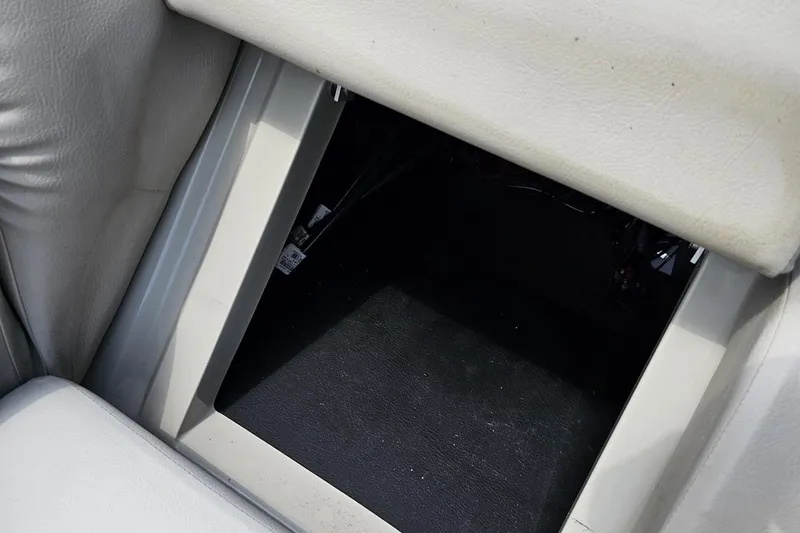 Slide: The Image of Storage compartment in 2016 Manitou 23 Legacy boat, featuring cushioned seating. - 82