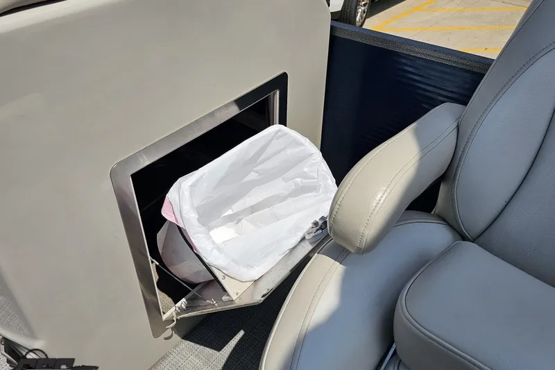 Slide: The Image of Interior of 2016 Manitou 23 Legacy with built-in trash compartment and leather seating. - 98