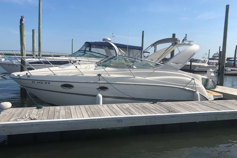 The Image of 2003 Maxum 2700 SCR boat docked at marina under clear blue sky. - 0