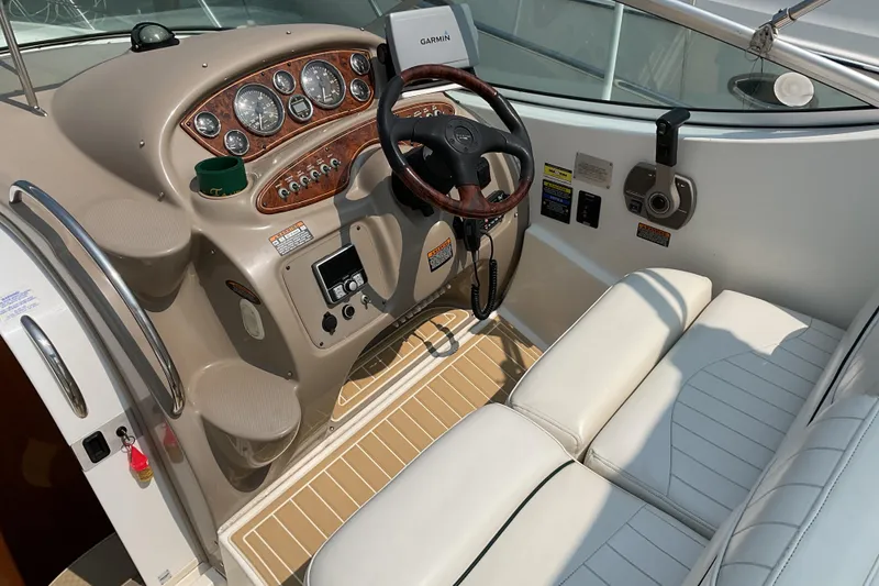 Slide: The Image of 2003 Maxum 2700 SCR boat cockpit with steering wheel and control panel. - 10
