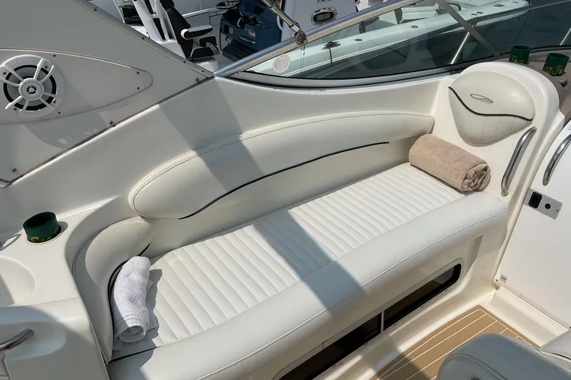 Slide: The Image of 2003 Maxum 2700 SCR boat interior with white seating and towels. - 14