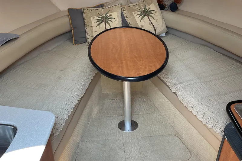 Slide: The Image of Interior of 2003 Maxum 2700 SCR boat with cozy seating and wooden table. - 15