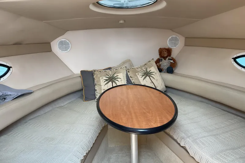 Slide: The Image of Interior of 2003 Maxum 2700 SCR boat with cozy seating and decorative pillows. - 16