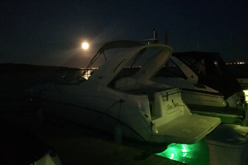 Slide: The Image of 2003 Maxum 2700 SCR boat docked at night under a full moon. - 24