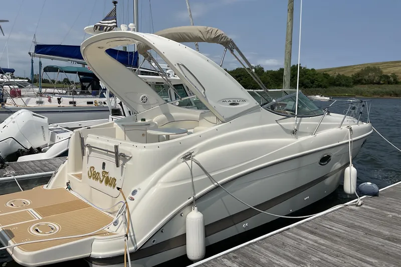 Slide: The Image of 2003 Maxum 2700 SCR boat docked at marina, featuring sleek design and spacious deck. - 7