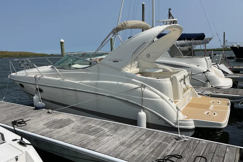Slide: The Image of 2003 Maxum 2700 SCR boat docked at marina, featuring sleek design and spacious deck. - 9