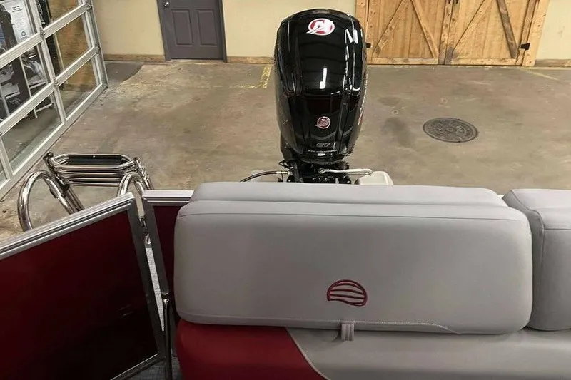 Slide: The Image of 2026 Sun Tracker PARTY BARGE® 20 DLX interior with motor, in a showroom setting. - 3