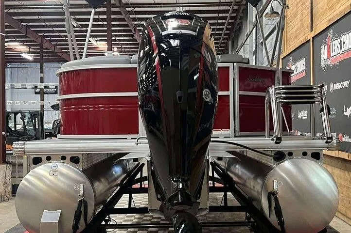 Slide: The Image of 2026 Sun Tracker PARTY BARGE® 20 DLX pontoon boat with Mercury outboard motor in showroom. - 4