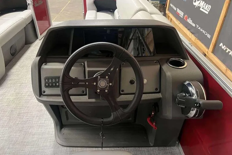 Slide: The Image of 2026 Sun Tracker PARTY BARGE® 20 DLX steering console with modern controls and cup holder. - 6