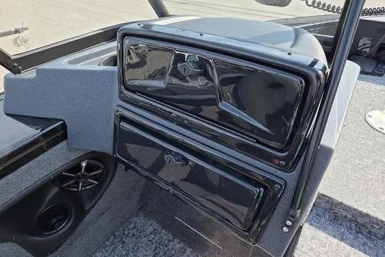 Slide: The Image of 2026 Tracker Targa V18 Combo boat interior with storage compartments and speaker. - 17