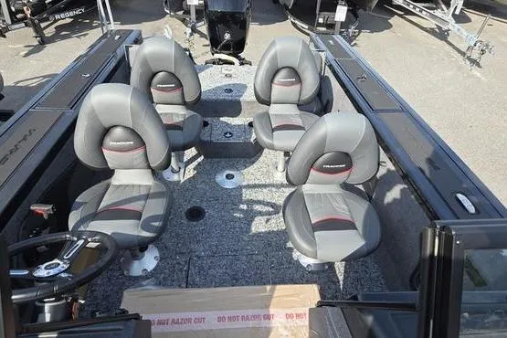 Slide: The Image of 2026 Tracker Targa V18 Combo boat interior with four gray seats and steering wheel. - 4