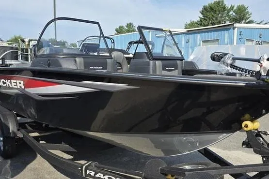 Slide: The Image of 2026 Tracker Targa V18 Combo boat on trailer, black exterior, parked outdoors. - 5