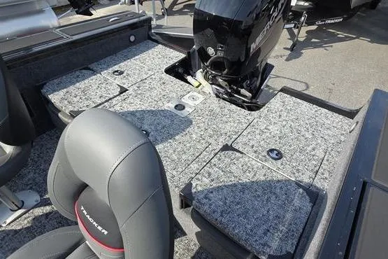 Slide: The Image of 2026 Tracker Targa V18 Combo boat interior with seating and motor, featuring gray upholstery. - 6
