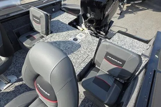 Slide: The Image of 2026 Tracker Targa V18 Combo boat interior with gray seating and motor. - 9