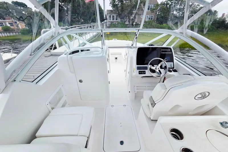 Slide: The Image of 2022 Edgewater 248 CX boat interior with modern dashboard and seating. - 14