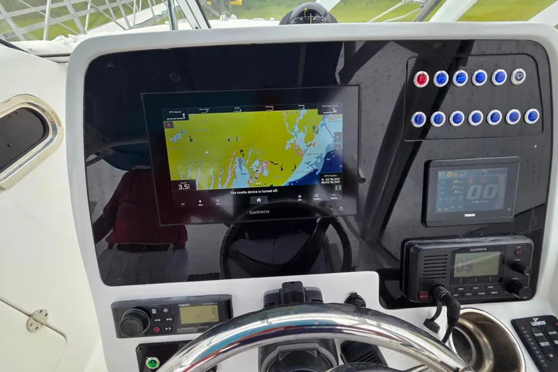 Slide: The Image of Edgewater 248 CX 2022 boat dashboard with Garmin navigation system and controls. - 5