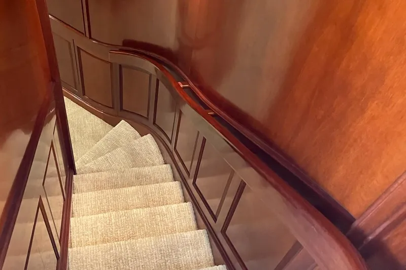 Slide: The Image of Luxurious 2001 Rayburn Flush Deck yacht interior with polished wood and scenic water views. - 10