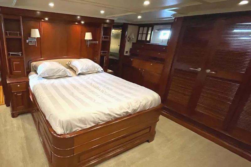 Slide: The Image of Luxurious 2001 Rayburn Flush Deck yacht kitchen with wood cabinetry and modern appliances. - 13